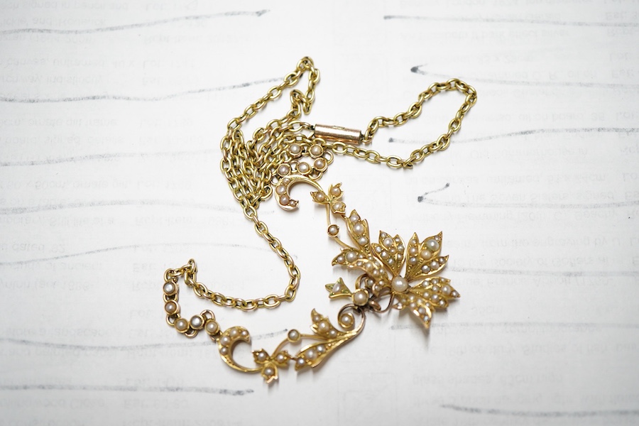 An Edwardian 9ct and split pearl cluster set drop pendant necklace, overall 44cm, gross weight 8 grams.